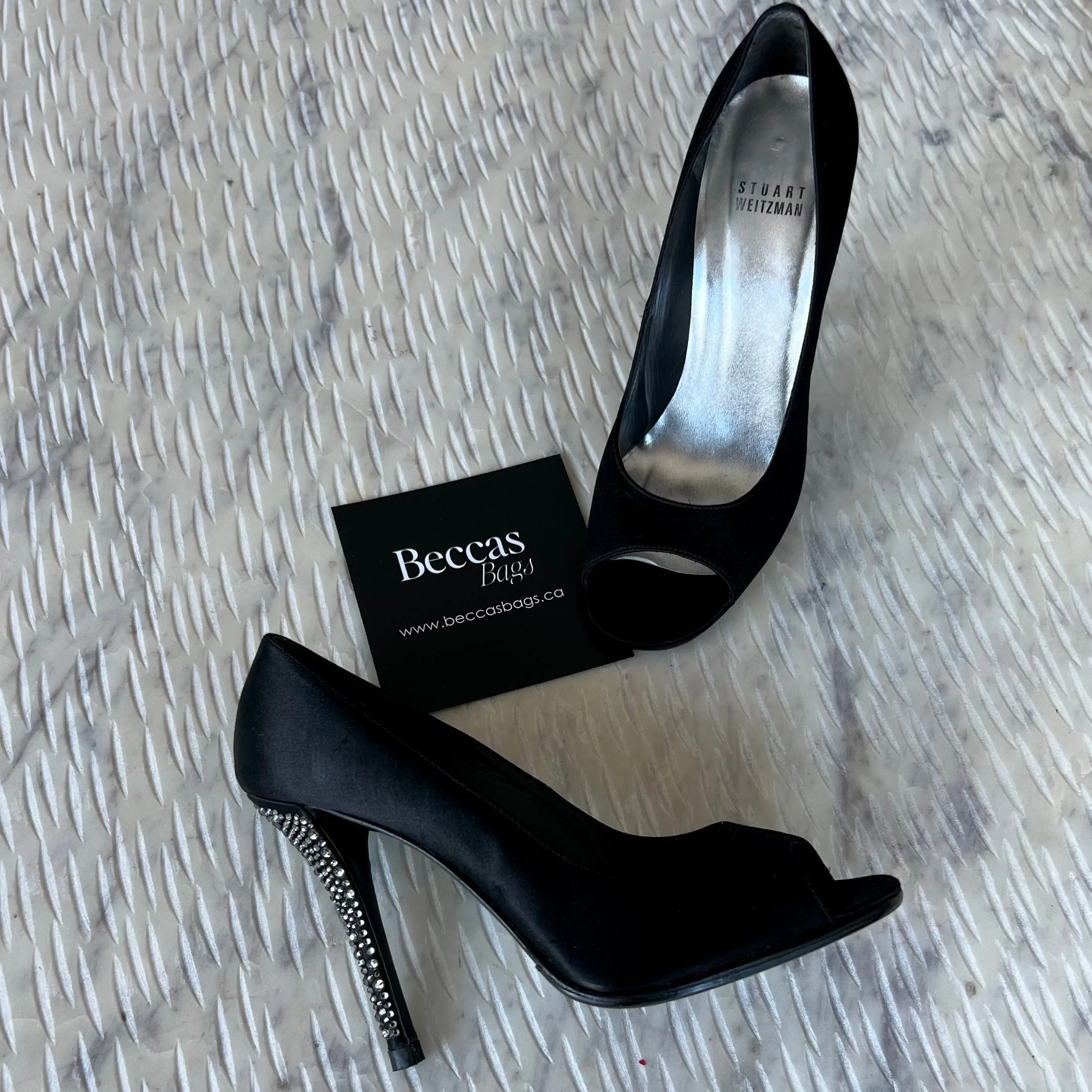 STUART
WEITZMAN
Black Satin Crystal Heel Peep Toe Pumps