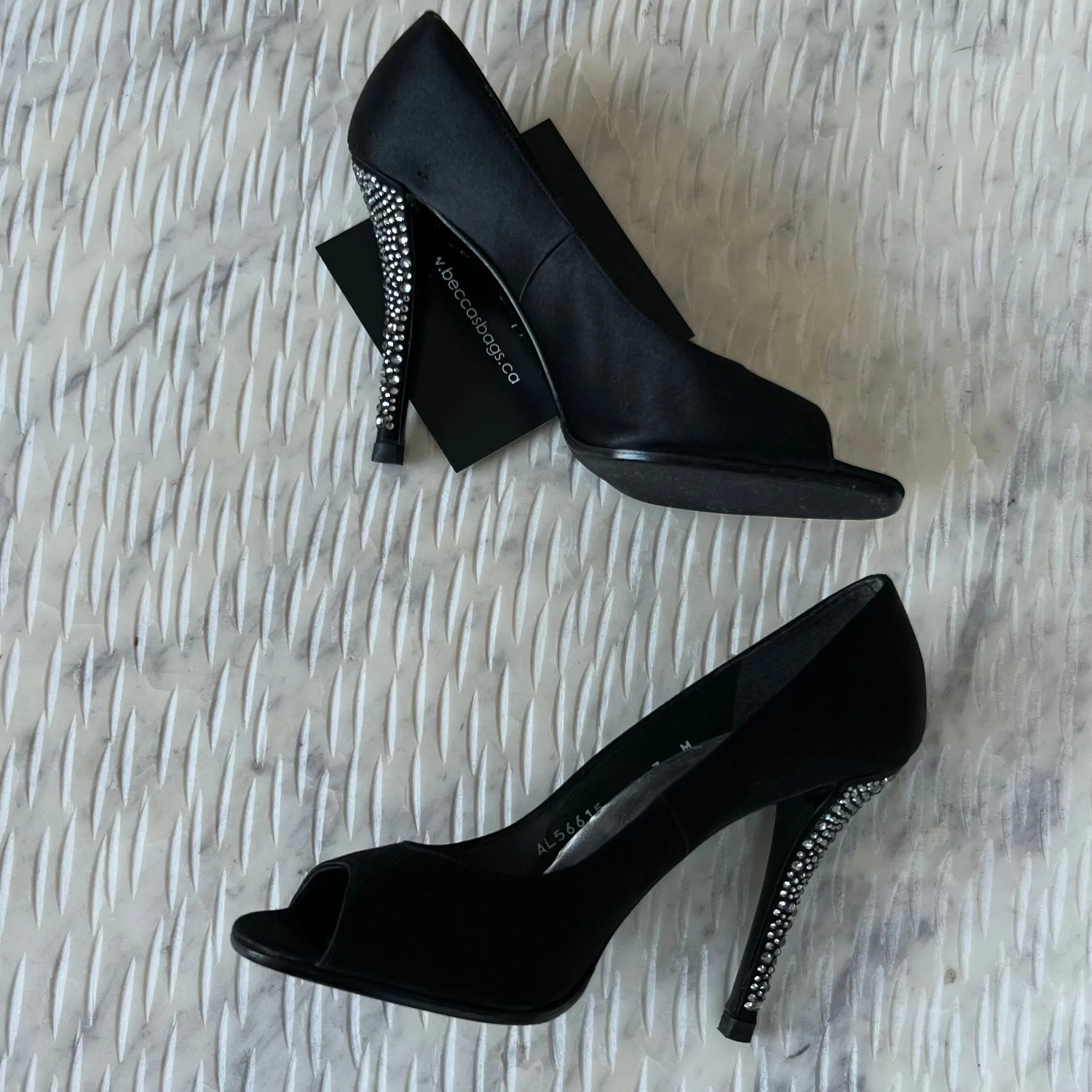STUART
WEITZMAN
Black Satin Crystal Heel Peep Toe Pumps